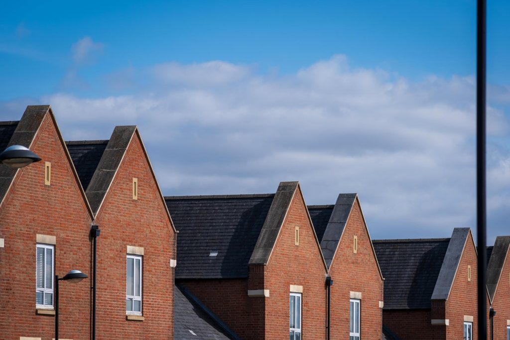 Rooftops of three red brick houses